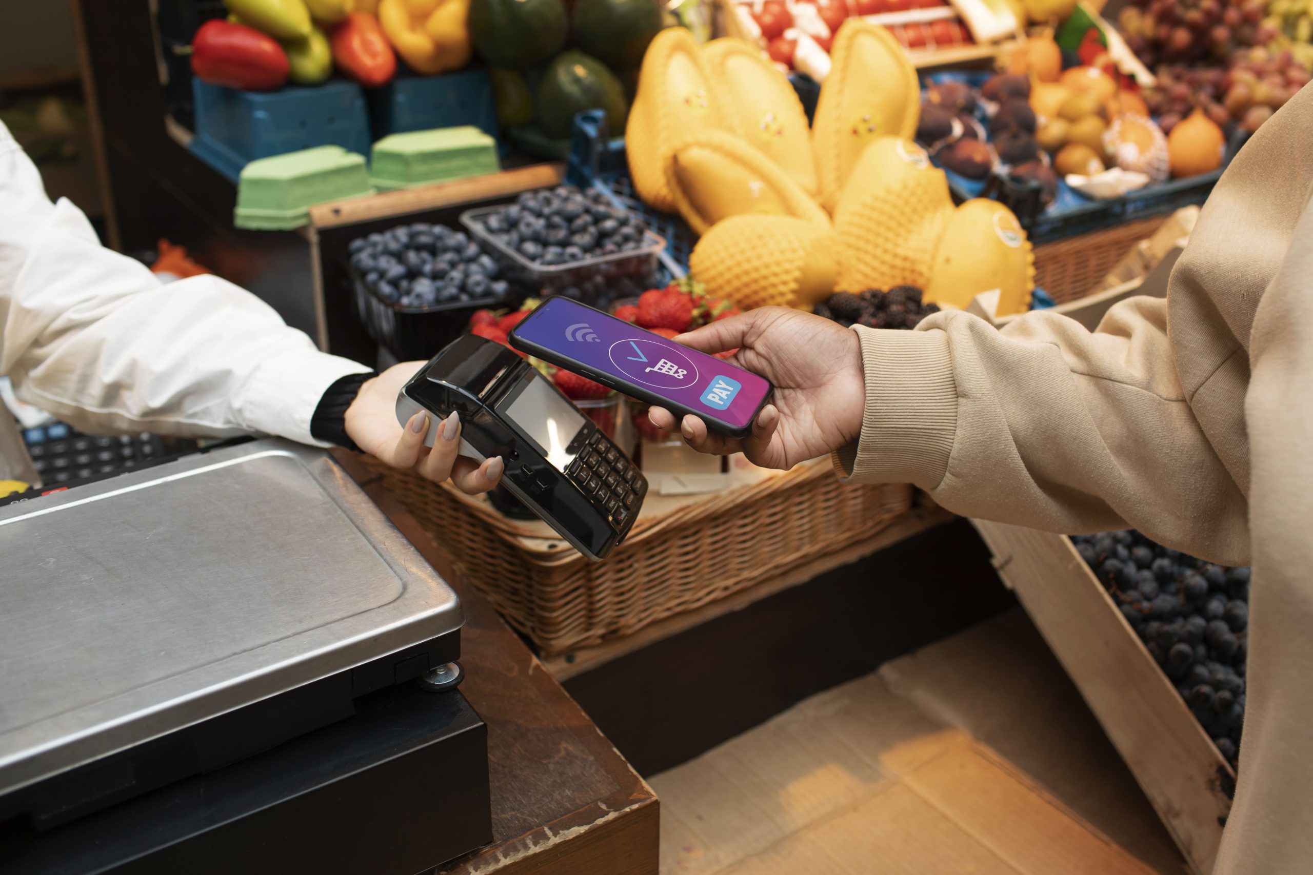 close-up-hand-paying-with-phone-min